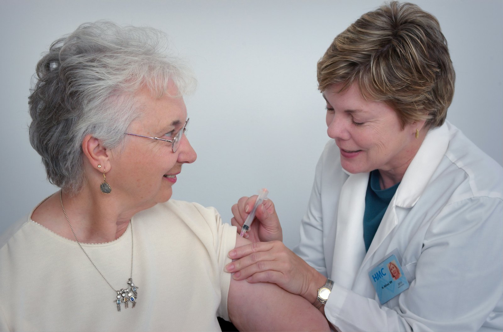 Clinician using a mobile app at a patient bedside